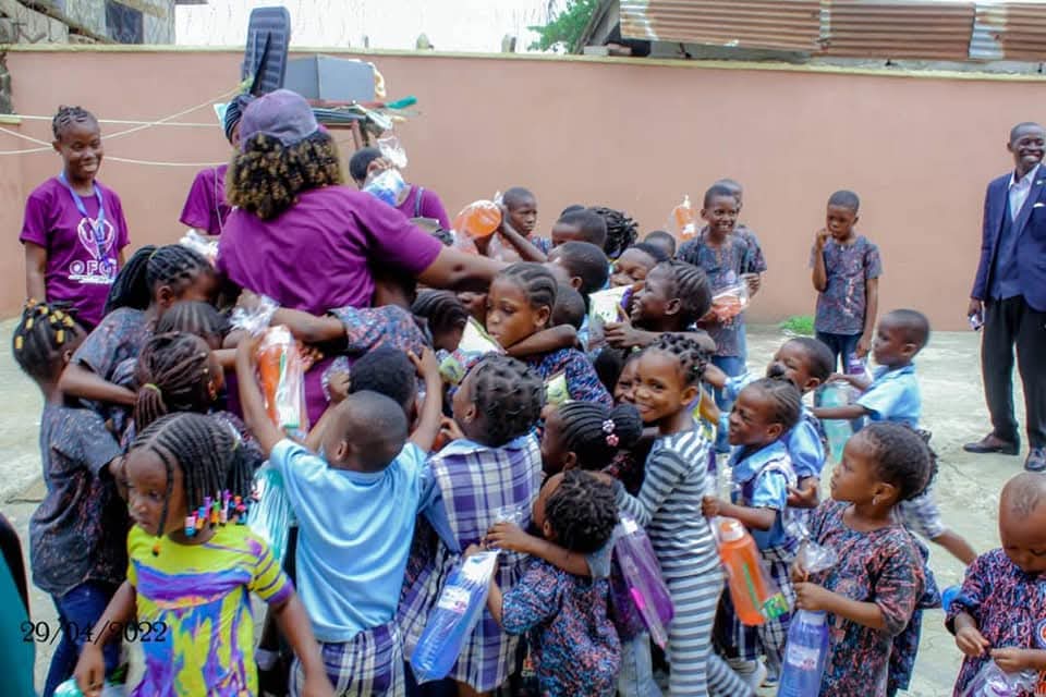 Children receiving gift packs during an outreach